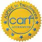 A carf accredited badge with stars on it.