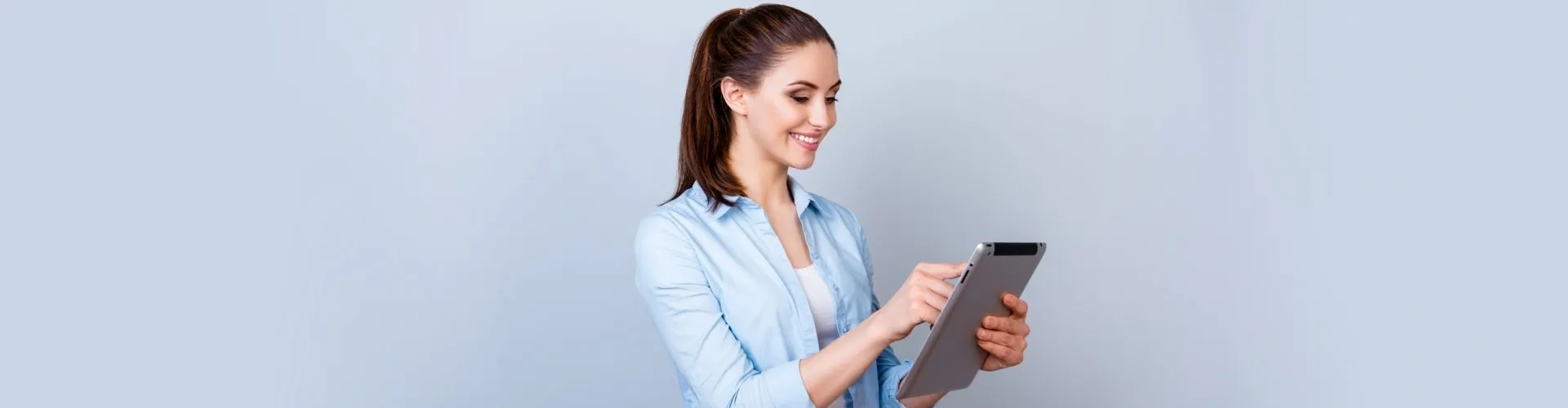 A woman holding an ipad in her hands.